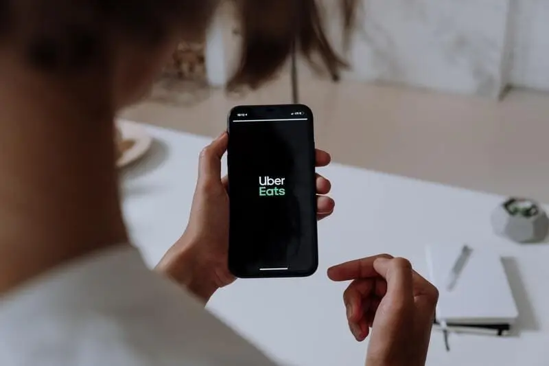 main tenant un smartphone avec application uber eats